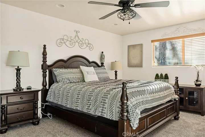 Primary suite with ceiling fan.