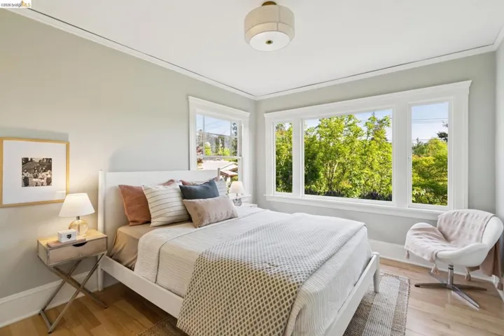 Bedroom featuring light wood-style flooring and ornamental molding