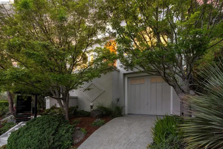 View of front facade featuring decorative driveway and stucco siding