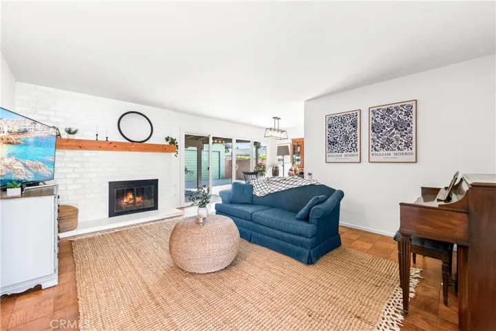 Bright white walls, abundant windows, and real wood floors create a cheerful interior.