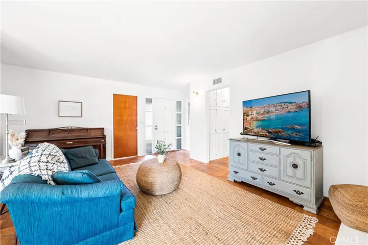 Bright white walls, abundant windows, and real wood floors create a cheerful interior.