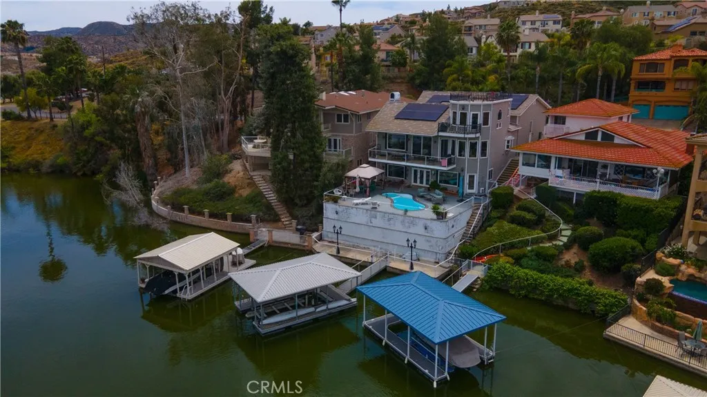 Aerial photo of backyard, pool, dock, rooftop deck.
