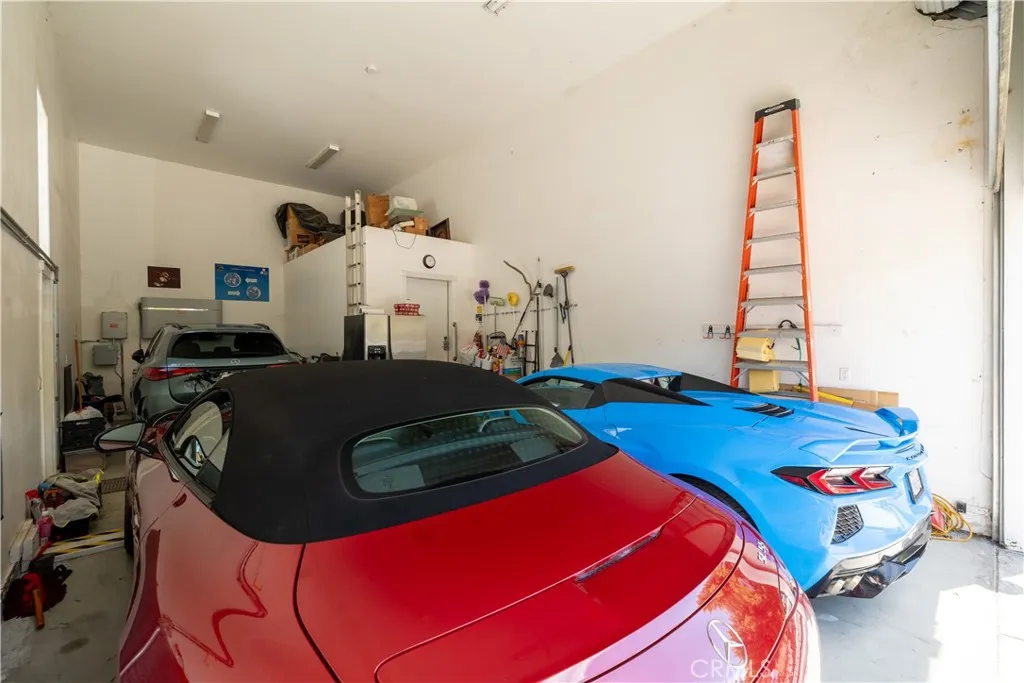 Versatile 3 car garage with 16.5' ceiling with roll up door. Could be used for RV, boat, cars, golf cart or add a car lift to increase the amount of cars that will fit in this garage.