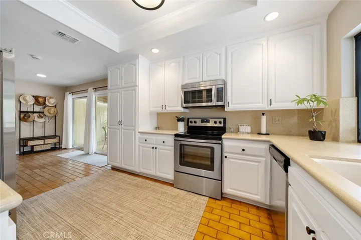 Lovely kitchen with round edged countertops. Plenty of storage space.