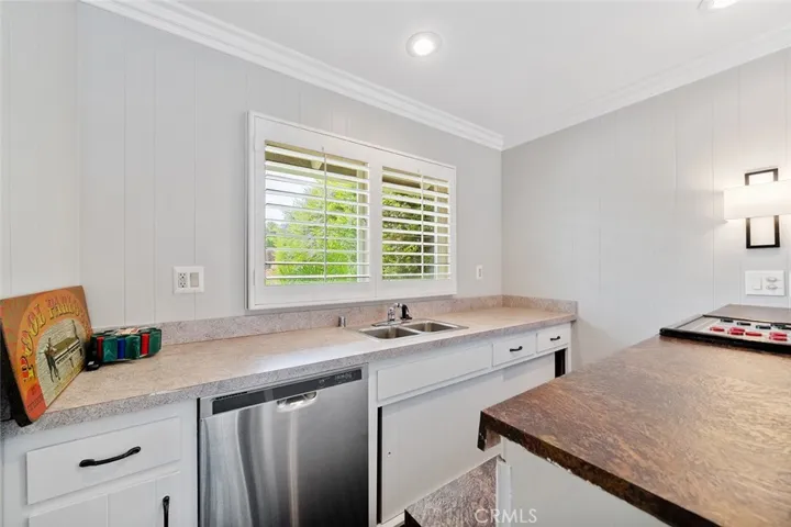 Wet bar with dishwasher. Window faces the front yard.