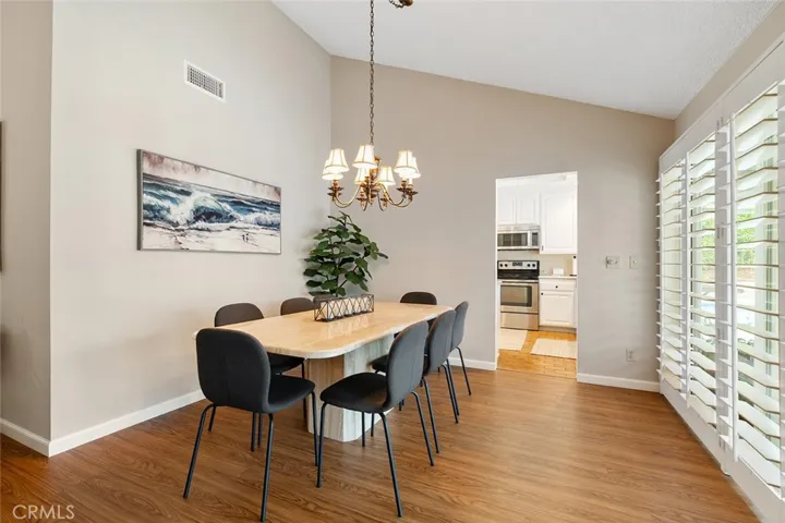 Gorgeous dining table and view of the backyard. Throughway to the kitchen.