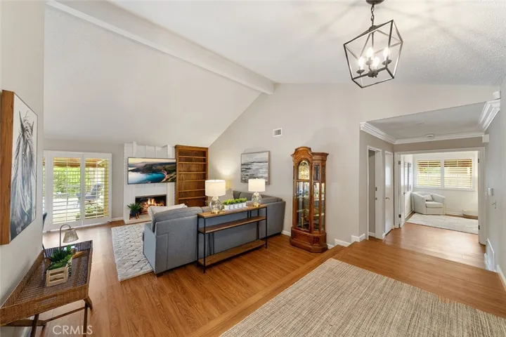 From the landing looking towards the formal living room and hallway with crown moulding to the bedrooms and 2 out of 3 bathrooms.