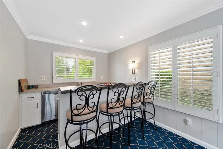 Wet bar with dishwasher and room to sit four comfortably.