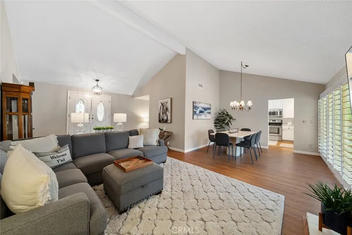 Spacious living and dining with view of the back. High ceilings. Throughway to the kitchen.