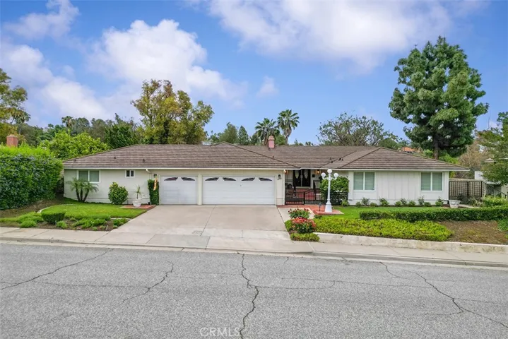 Pride of ownership. Bonus room left side of the garage. Two windows on the right belong to two of the four bedrooms.Double door entry up a few steps.