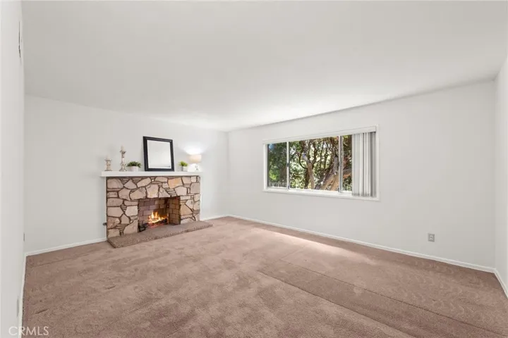 Primary Suite with fireplace and large window.