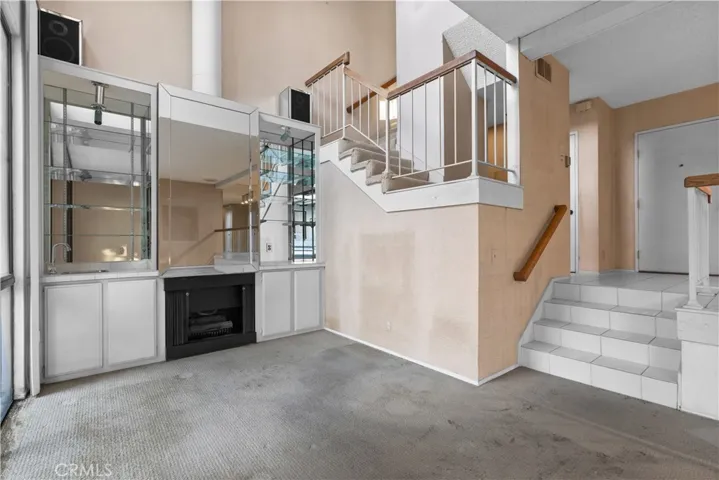 Living area with fireplace, built-in cabinetry, and a split-level layout.