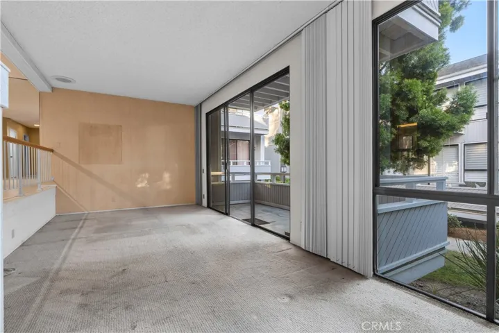 Living area with large sliding glass doors and access to a private balcony.