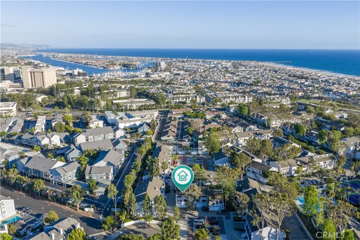 Aerial view highlighting the home’s location within Newport Crest, with close proximity to the beach, harbor, and surrounding coastal lifestyle.