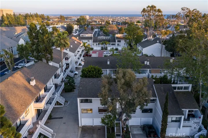 Elevated view highlighting the home’s position within the community, with distant ocean views.