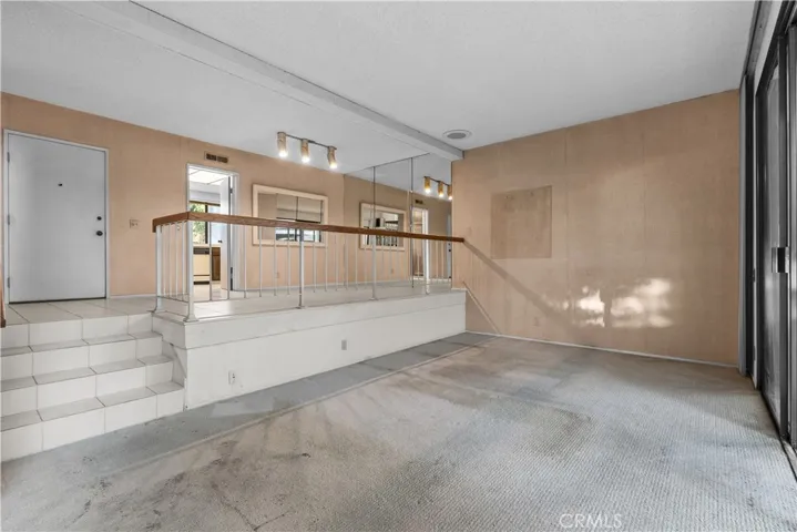 Living area with a split-level layout and adjacent dining space.