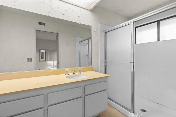 En-suite bathroom with vanity and walk-in shower.