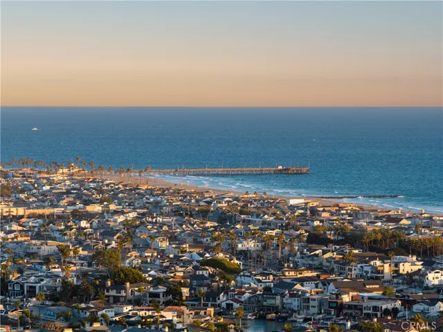 Coastal view capturing the Newport Beach coastline, harbor, and surrounding community.