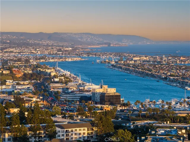 Panoramic view of Newport Harbor, highlighting the waterfront, marinas, and Newport Beach coastline.