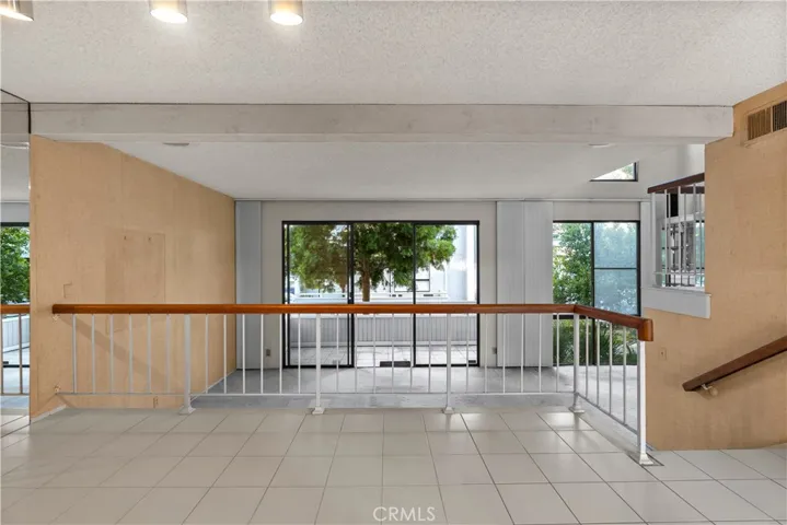 Living / main level: Open-concept living area with expansive windows and sliding glass doors.