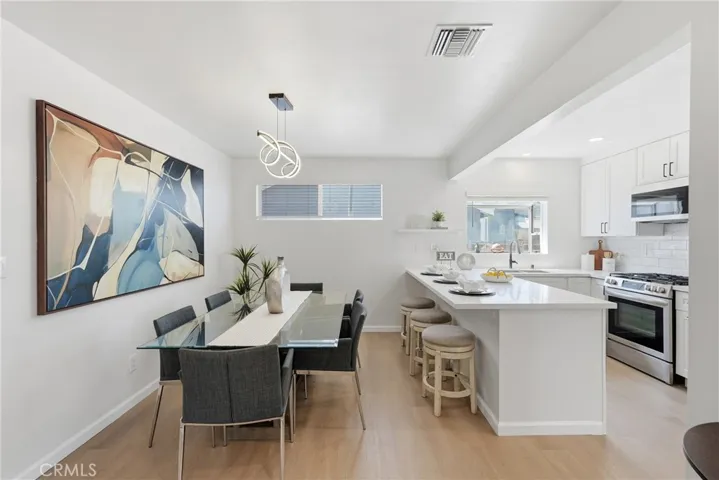 The dining area is ideally situated next to the kitchen, offering ample seating for both everyday living and entertaining guests.