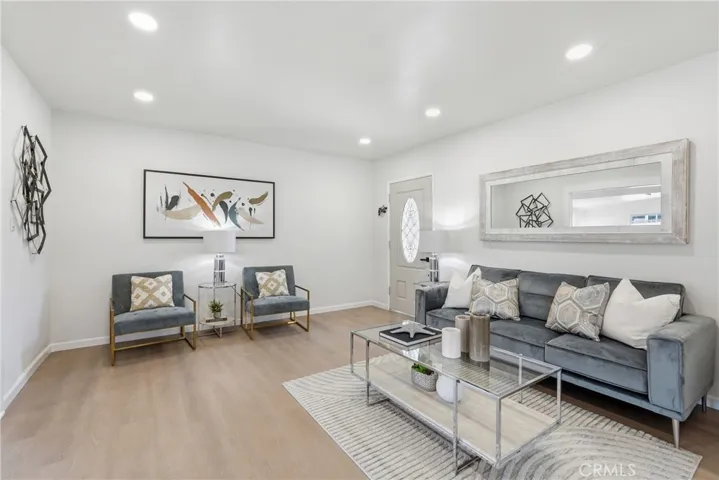 Living room has recessed lighting and LVP flooring throughout.