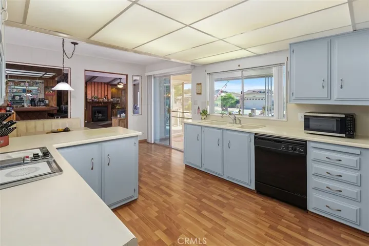 Kitchen has sliding glass door out to covered patio.