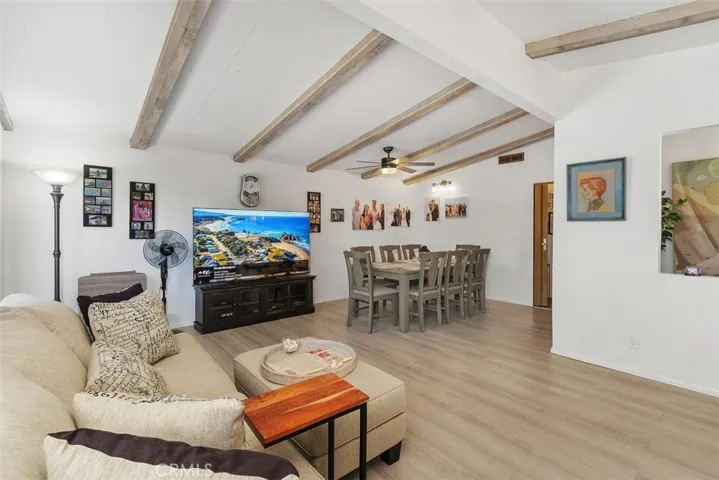 Upgraded floors, walls, beamed ceilings in entry as well as living/dining room