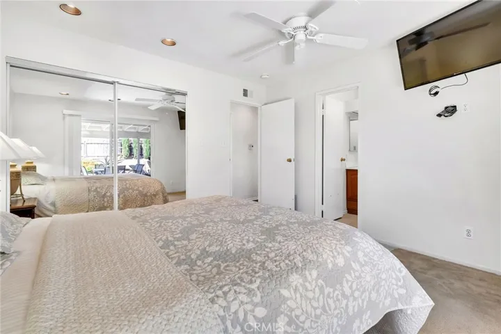 Primary bedroom, large bright room with ensuite bathroom and patio access.