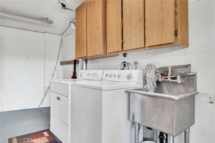 Washer and dryer, work sink in the garage. Built-in cabinets along every wall provide ample storage.