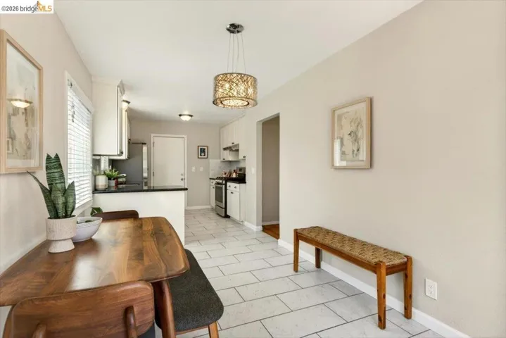 Dining room with baseboards and light tile patterned floors