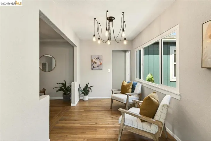 Sitting room with a chandelier and wood finished floors