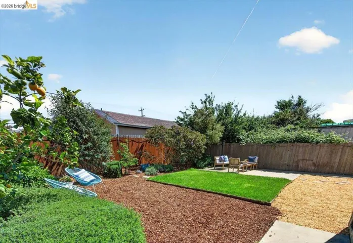 Fenced backyard featuring a patio and an outdoor lounge area