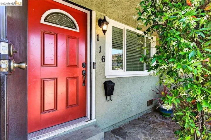 Property entrance featuring stucco siding