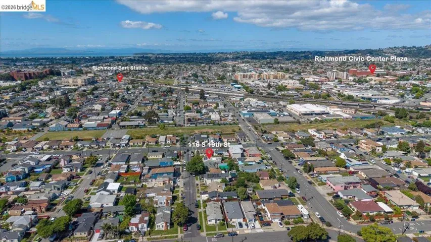 Aerial view of property and surrounding area with nearby urban area