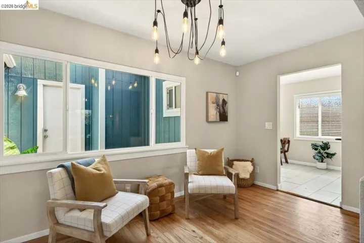 Living area featuring wood finished floors and a chandelier