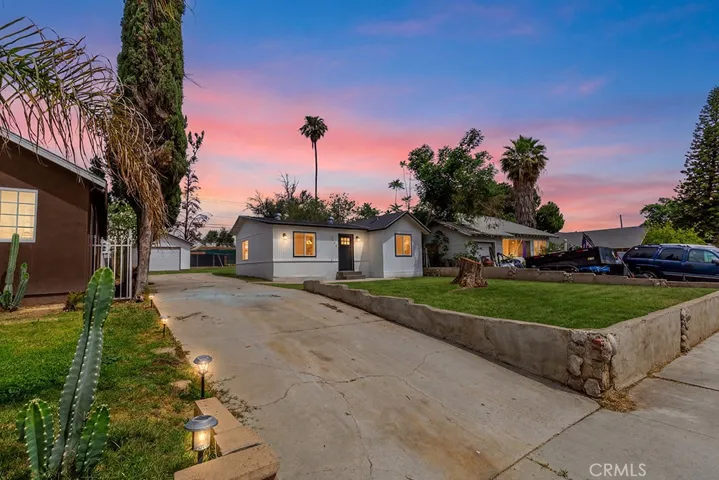 Photo has been digitally enhanced to show what the front yard would look like with grass. It is currently dirt.