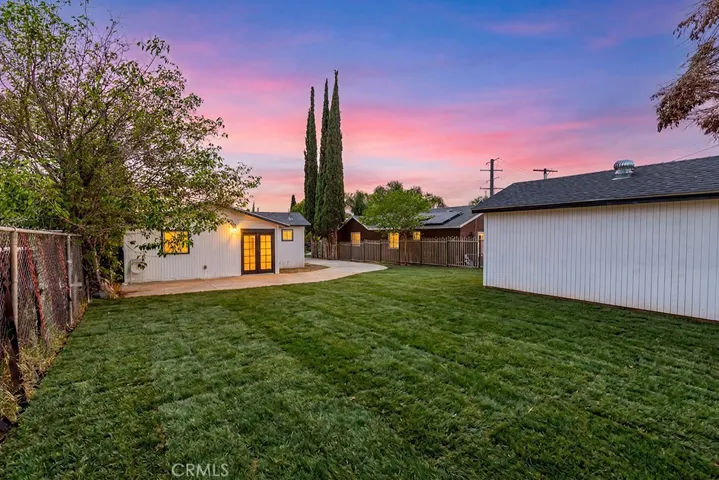 Photo has been digitally enhanced to show what the front yard would look like with grass. It is currently dirt.
