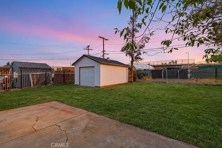 Photo has been digitally enhanced to show what the front yard would look like with grass. It is currently dirt.