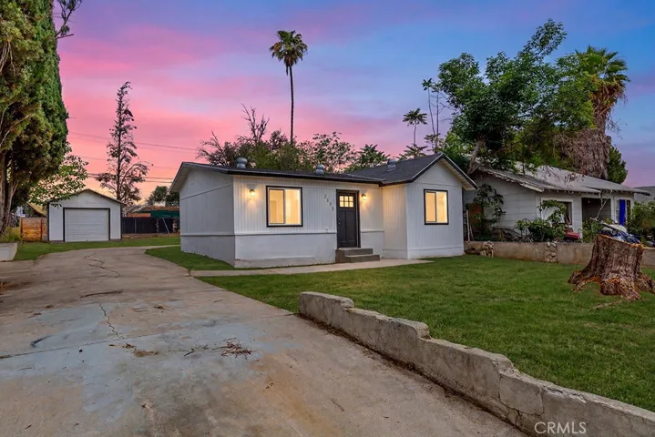 Photo has been digitally enhanced to show what the front yard would look like with grass. It is currently dirt.