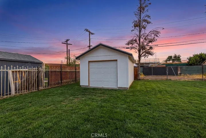 Photo has been digitally enhanced to show what the front yard would look like with grass. It is currently dirt.