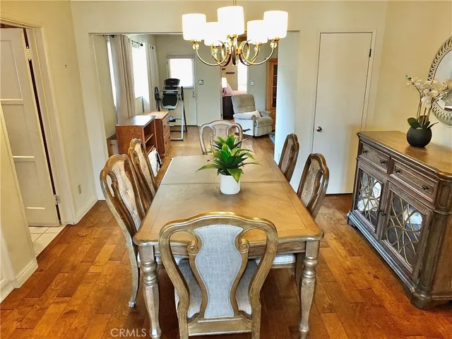 Formal dining room opens to relaxing den with fireplace