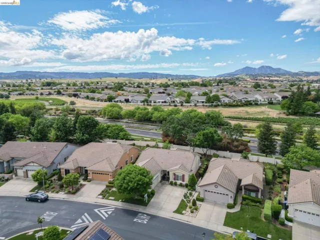 Aerial perspective of suburban area featuring a mountain backdrop
