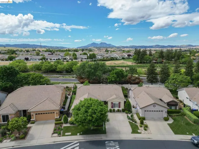 Aerial perspective of suburban area featuring a mountain backdrop