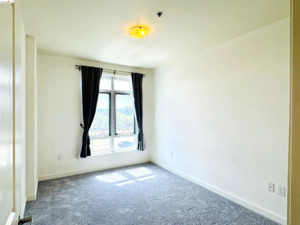 Unfurnished room featuring carpet flooring and baseboards