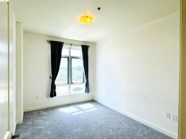 Unfurnished room featuring carpet flooring and baseboards
