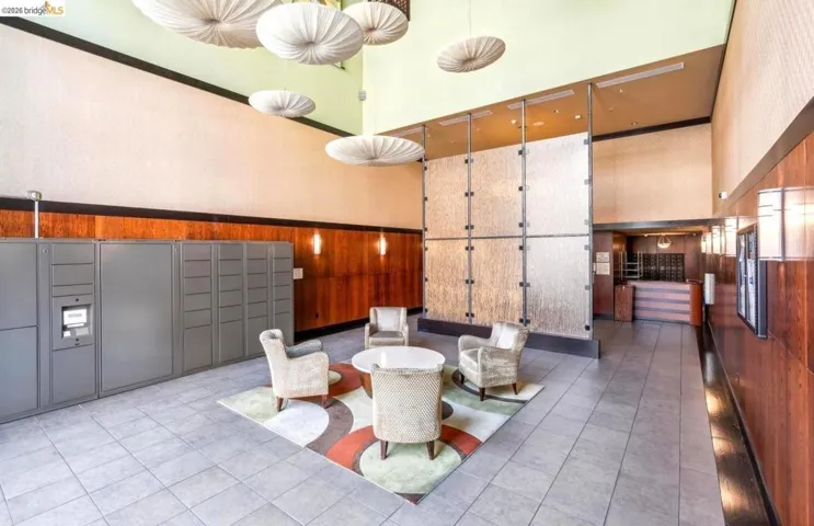 Common area with wood walls, a high ceiling, and a wainscoted wall
