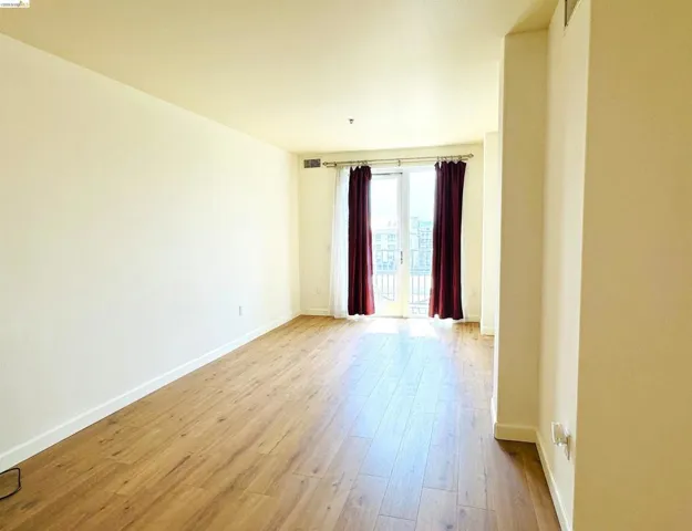Empty room with baseboards and light wood-style floors