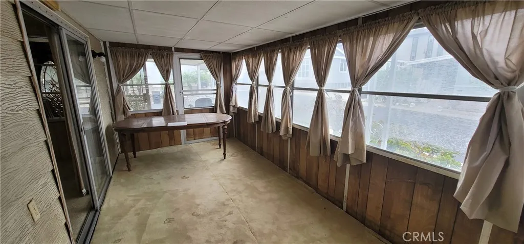 Table is blocking the direct access to the front porch for this enclosed porch.