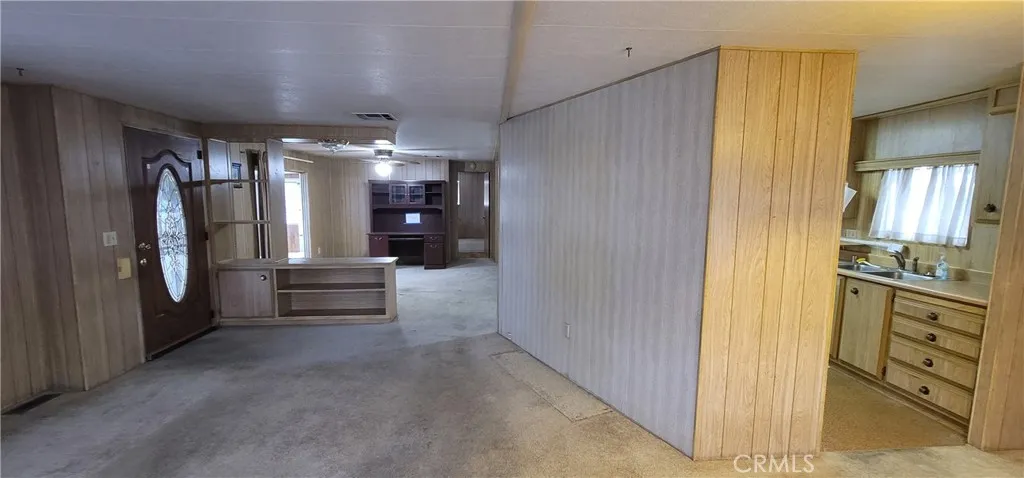 View of front door and pony wall to family room area, border wall with kitchen. Remove these two walls to make the unit much more spacious. (see closed unit #391 for improvement ideas)